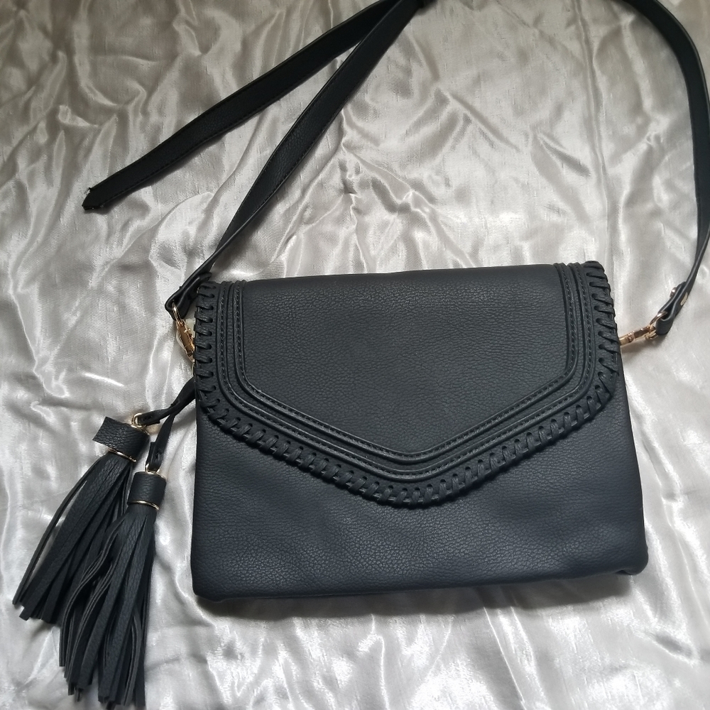 Small black purse with short shoulder strap.